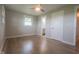 Bright bedroom with hardwood floors and a view into the bathroom at 7302 N Banta Rd, Bargersville, IN 46106