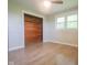 Bright bedroom with hardwood floors, ceiling fan, closet, and natural light from the windows at 7302 N Banta Rd, Bargersville, IN 46106