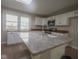 Modern kitchen island featuring granite countertop with stainless steel faucet and sink at 7302 N Banta Rd, Bargersville, IN 46106