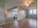 Spacious living room with hardwood floors, wooden beam, and an open view to the kitchen at 7302 N Banta Rd, Bargersville, IN 46106
