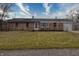 Brick ranch house with a spacious lawn, attached garage, and a front porch at 770 Berkley Dr, Fortville, IN 46040