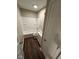 Clean bathroom with white tiled shower over tub, new vanity, new dark flooring, and updated fixtures at 10229 Baribeau Ln, Indianapolis, IN 46229