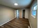 Bright bedroom with wood-look flooring, closet, fresh paint, and plenty of natural light at 10229 Baribeau Ln, Indianapolis, IN 46229