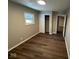 Cozy bedroom featuring hardwood-style floors, closet, and a window allowing for natural light at 10229 Baribeau Ln, Indianapolis, IN 46229