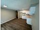 Well-lit kitchen with white cabinets, neutral countertops, new flooring, and fresh paint at 10229 Baribeau Ln, Indianapolis, IN 46229