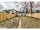 View of the fenced backyard with grass and patio at 1133 Olive St, Indianapolis, IN 46203