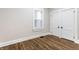 Bright bedroom featuring hardwood floors, window, and double closets at 1133 Olive St, Indianapolis, IN 46203