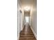 Hallway featuring hardwood floors, neutral walls, and white doors and trim at 1133 Olive St, Indianapolis, IN 46203