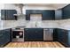 Modern kitchen featuring stainless appliances, white countertops, a subway tile backsplash and updated fixtures at 1133 Olive St, Indianapolis, IN 46203
