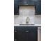 Close up of stainless steel sink and faucet, cabinets, quartz countertops and tile backsplash at 1133 Olive St, Indianapolis, IN 46203