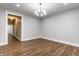 Bright living room featuring hardwood floors and a modern light fixture at 1133 Olive St, Indianapolis, IN 46203