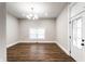 Bright living room featuring hardwood floors and a modern light fixture at 1133 Olive St, Indianapolis, IN 46203