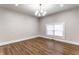 Bright living room featuring hardwood floors and a modern light fixture at 1133 Olive St, Indianapolis, IN 46203