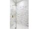 Beautiful marble tiled shower with glass enclosure and rainfall showerhead at 1133 Olive St, Indianapolis, IN 46203
