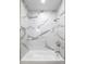 Modern shower with white marble-style tile, bathtub and brushed gold fixtures at 1133 Olive St, Indianapolis, IN 46203