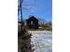 Backyard view with a home featuring dark siding and a foundation for outdoor construction at 1523 N Beville Ave, Indianapolis, IN 46201
