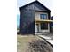 Charming two-story home with black siding and a covered porch, showcased with a blue sky backdrop at 1523 N Beville Ave, Indianapolis, IN 46201
