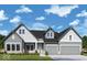 Charming two-story home featuring a symmetrical facade, gray siding, and a two-car garage at 19826 Chatham Shore Ln, Westfield, IN 46074