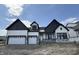 New two-story home boasts an attached three-car garage, modern architecture, and dark-trimmed windows at 19826 Chatham Shore Ln, Westfield, IN 46074