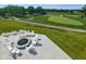 Inviting outdoor firepit area with comfortable Adirondack chairs, perfect for gatherings with golf course views at 19826 Chatham Shore Ln, Westfield, IN 46074