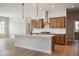 Modern kitchen features a large island with pendant lighting and stainless steel appliances at 19826 Chatham Shore Ln, Westfield, IN 46074