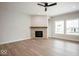 Inviting living room features a cozy stone fireplace, recessed lights, and expansive windows at 19826 Chatham Shore Ln, Westfield, IN 46074
