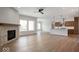 Open-concept layout showcasing the living room with fireplace adjoining kitchen with a large island at 19826 Chatham Shore Ln, Westfield, IN 46074