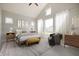 Serene main bedroom with vaulted ceilings, large windows, and comfortable furnishings at 19826 Chatham Shore Ln, Westfield, IN 46074