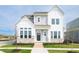 Two story home with mixed siding, stone accents, black front door, covered porch, and manicured front lawn at 19995 Meadow Neck Rd, Westfield, IN 46074