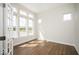 Bright living room with hardwood floors, white walls, large windows, and white trim provides a serene living space at 19995 Meadow Neck Rd, Westfield, IN 46074