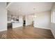 Open floorplan featuring hardwood floors, a gray kitchen, modern lighting, and large windows at 19995 Meadow Neck Rd, Westfield, IN 46074