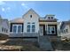 Two-story home featuring white and dark siding, large windows, and a front porch with steps at 20017 Old Dock Rd, Westfield, IN 46074