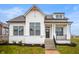 Charming new build with white siding, black framed windows, beautiful landscaping and a welcoming front porch at 20017 Old Dock Rd, Westfield, IN 46074