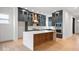 Modern kitchen with gray cabinets, marble backsplash, stainless steel appliances, and a large center island at 20017 Old Dock Rd, Westfield, IN 46074