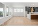 Spacious living room featuring new floors and large windows providing plenty of natural light next to kitchen at 20017 Old Dock Rd, Westfield, IN 46074