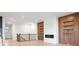 Bright living room with modern fireplace, wood accent wall, new floors and dark railing to upstairs at 20017 Old Dock Rd, Westfield, IN 46074