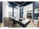 Modern office featuring a large desk, modern chair, natural lighting, and a blue accent wall at 20017 Old Dock Rd, Westfield, IN 46074