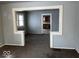 Living room with a view of the open archway to the kitchen at 2029 Laurel St, Indianapolis, IN 46203