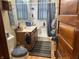 Functional bathroom featuring a vanity, toilet, and shower with blue accents at 214 S Howard St, Oxford, IN 47971