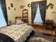 Cozy bedroom featuring a patterned quilt and classic decor elements at 214 S Howard St, Oxford, IN 47971