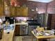 Charming kitchen with stainless steel appliances, brick wall and wooden cabinets at 214 S Howard St, Oxford, IN 47971