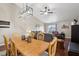 Open-concept dining area with a wooden table and chairs, seamlessly flowing into the living room at 2152 Mugo Pine Ct, Greenwood, IN 46143