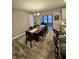 Dining area featuring a long wooden table with seating and natural light from nearby windows at 253 Darrough Dr, Greenwood, IN 46143