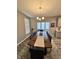 Elegant dining room with a large wooden table, seating for ten, and a chandelier at 253 Darrough Dr, Greenwood, IN 46143