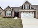 Charming single-Gathering home boasting a brick facade, complemented by a two-car garage and well-maintained lawn at 253 Darrough Dr, Greenwood, IN 46143