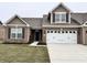Charming single-Gathering home boasting a brick facade, complemented by a two-car garage and well-maintained lawn at 253 Darrough Dr, Greenwood, IN 46143