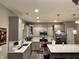 Well-lit kitchen featuring stainless steel appliances, gray cabinets, and an island with barstools at 253 Darrough Dr, Greenwood, IN 46143