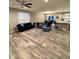 Open-concept living room, showcasing wood floors, comfortable sofas, and an adjacent kitchen with modern fixtures at 253 Darrough Dr, Greenwood, IN 46143