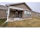 This brick house features a covered patio with fan, seating and sliding glass doors to the interior at 253 Darrough Dr, Greenwood, IN 46143