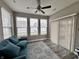 Bright sunroom features a ceiling fan, multiple windows, wood-look flooring, and access to the outdoors at 253 Darrough Dr, Greenwood, IN 46143